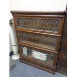 An early twentieth century stacking leaded glass oak bookcase