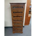 An Eastern hardwood chest of seven glazed drawers