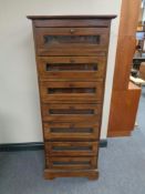 An Eastern hardwood chest of seven glazed drawers