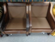 A pair of mid century Danish brown leather armchairs (lacking cushions)