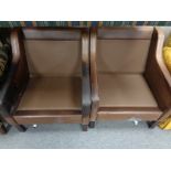 A pair of mid century Danish brown leather armchairs (lacking cushions)