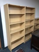 Two sets of pine effect open bookshelves,