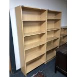 Two sets of pine effect open bookshelves,