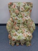 A continental armchair in floral upholstery