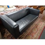 A black faux leather two seater settee