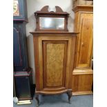 A nineteenth century walnut bow fronted cabinet on cabriole legs with mirror back