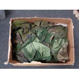 A box of army surplus clothing,