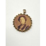 A yellow gold locket with DLI portrait