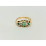 An antique 18ct gold emerald and diamond ring, size M1/2 CONDITION REPORT: 3.