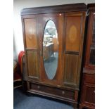 A late Victorian inlaid mahogany mirror door wardrobe