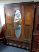 A late Victorian inlaid mahogany mirror door wardrobe