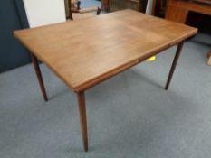 A mid century Danish teak pull out table