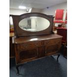 An Edwardian oak mirror backed sideboard