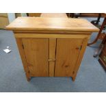 A pine two door low cupboard