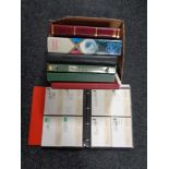 A box of seven folders of commemorative stamps,