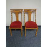 A pair of Syrian style ornate dining chairs in a red fabric