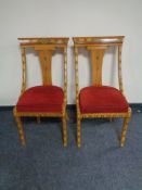 A pair of Syrian style ornate dining chairs in a red fabric