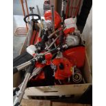 A crate of petrol garden multi tool engines and parts