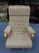 A continental easy chair in striped buttoned upholstery