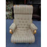 A continental easy chair in striped buttoned upholstery