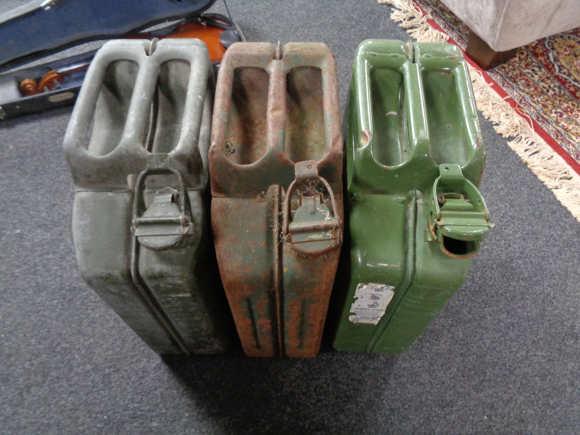 Three metal jerry cans