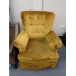 An armchair in mustard buttoned fabric