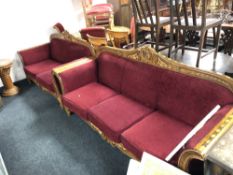 A Syrian ornate two seater and three seater scroll arm settees upholstered in red fabric