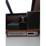 A Tellux teak cased turn table with eight track stereo together with a pair of teak cased speakers
