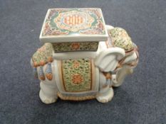 A glazed pottery elephant plant stand