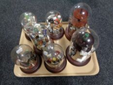 A tray of seven thimble display stands under domes and a large quantity of china and metal thimbles