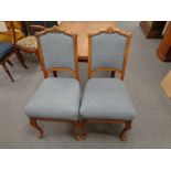 A pair of continental oak dining chairs