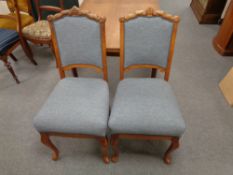 A pair of continental oak dining chairs