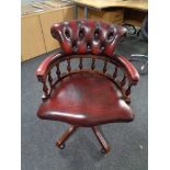 A Chesterfield style buttoned leather swivel captains chair