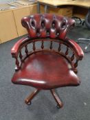 A Chesterfield style buttoned leather swivel captains chair