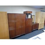 A four piece teak G Plan bedroom suite comprising double door wardrobe, linen chest,