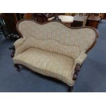 A late nineteenth century mahogany salon settee in striped classical upholstery