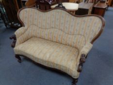A late nineteenth century mahogany salon settee in striped classical upholstery