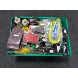 A crate of tools, bungee cord, socket adapter, palm sander,