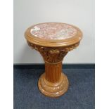 A carved pine marble topped plant pedestal