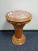 A carved pine marble topped plant pedestal