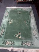 A green fringed Chinese carpet