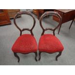 A pair of nineteenth century mahogany baloon backed dining chairs