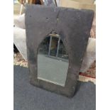 A slate framed arched topped mirror