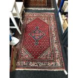 A Persian rug, 159cm by 101cm.