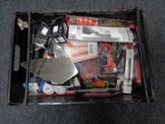 A crate of new tools, compact staple gun, wire brush, cable ties,