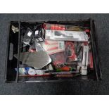 A crate of new tools, compact staple gun, wire brush, cable ties,