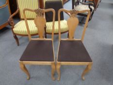A set of twelve oak dining chairs (one lacking cushion)