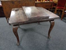 A Victorian mahogany wind out dining table with leaf and winder