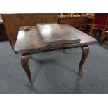 A Victorian mahogany wind out dining table with leaf and winder