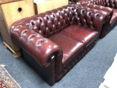 A Chesterfield style red buttoned leather two seater settee